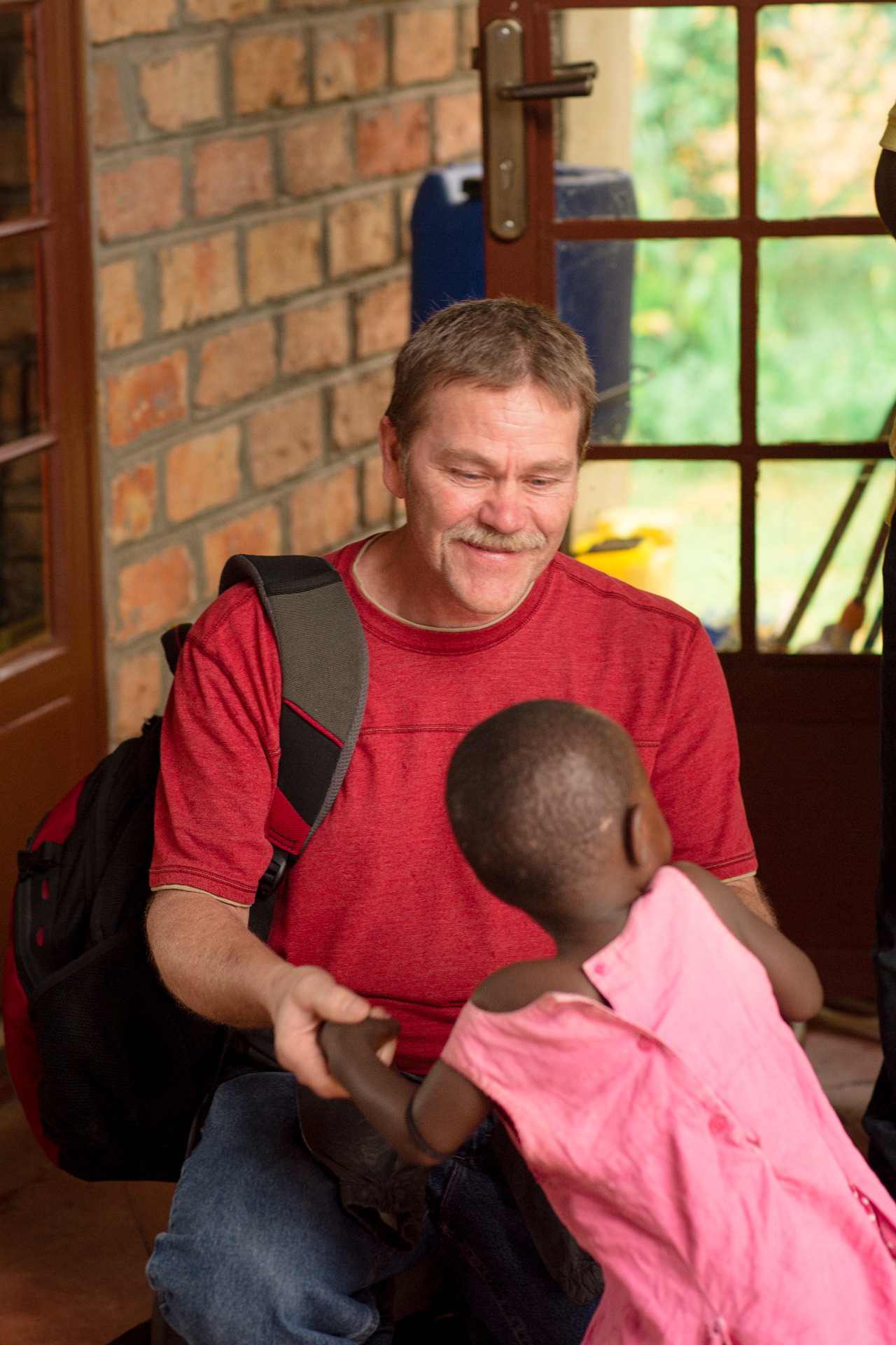 Team member connecting with community child